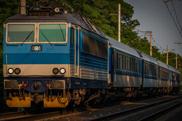 Trains and whistle stop Olesko in central Bohemia in sunset orange evening