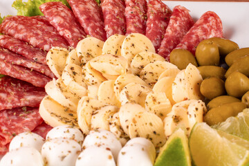 portion of cheese and salami on wooden background
