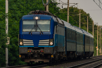 Trains and whistle stop Olesko in central Bohemia in sunset orange evening