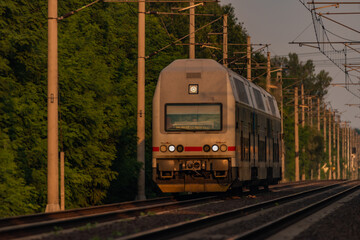 Trains and whistle stop Olesko in central Bohemia in sunset orange evening