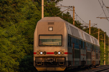Trains and whistle stop Olesko in central Bohemia in sunset orange evening
