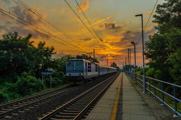 Trains and whistle stop Olesko in central Bohemia in sunset orange evening