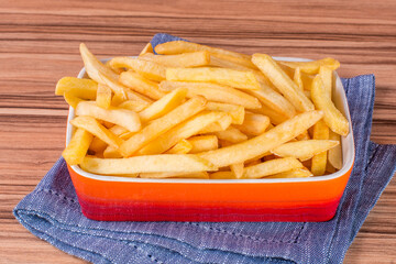 portion of potato chips on wooden background