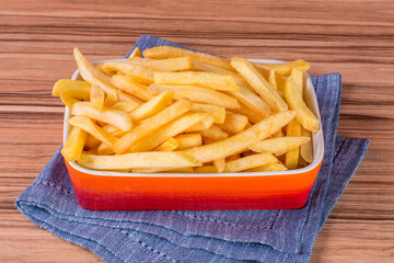 portion of potato chips on wooden background