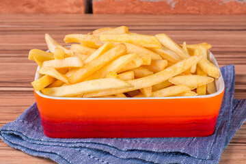 portion of potato chips on wooden background