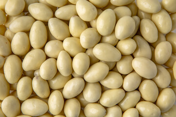 Candies. Almonds in white chocolate. Desserts for candy bars. Little white dragees