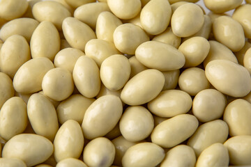 Candies. Almonds in white chocolate. Desserts for candy bars. Little white dragees