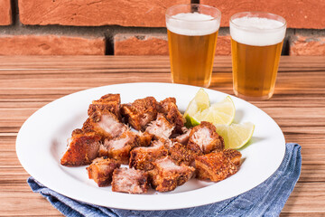 portion of pork cracklings on wooden background