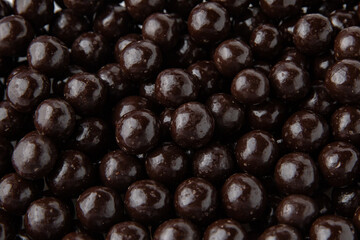 Hazelnuts in dark chocolate, dragees. Desserts for Candybar. Small round candies.