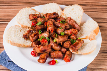 sausage portion with wood and brick background