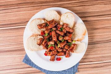 sausage portion with wood and brick background