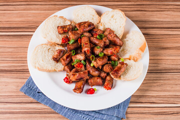 sausage portion with wood and brick background