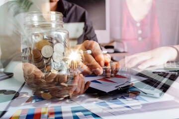 The hand of a man with a light bulb And there is a gear icon in it And he is using a notebook computer. The idea of ​​inspiration from online technology.innovation idea concept.