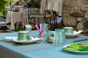 Traditional breakfast served outdoor on terrace in small village hotel in Provence