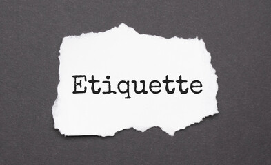 ETIQUETTE sign on the torn paper on the black background