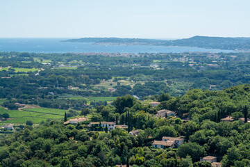 View on valley and sea from ancient french village Grimaud, touristic destination with ruines fortress castle on top, Var, Provence, France