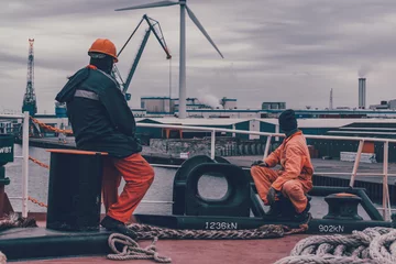 Fotobehang Seafarers watching windturbine during ship manouvering v2 © fratdd