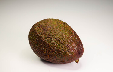 avocado lies on a white table