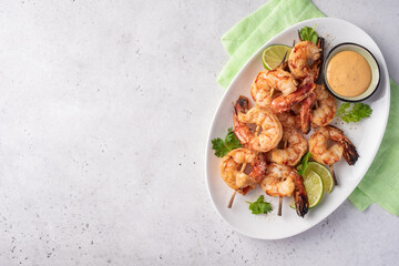 Grilled shrimps. Shrimps skewers, lime and sauce