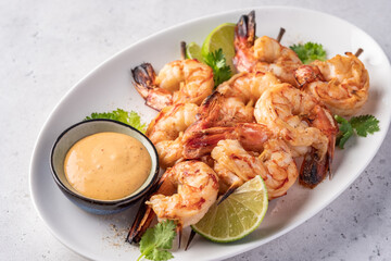Grilled shrimps. Shrimps skewers, lime and sauce