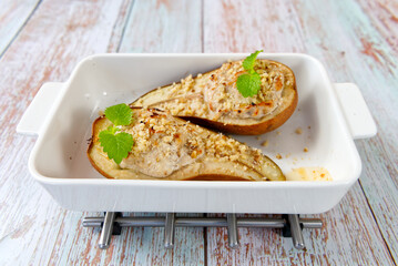 Honey juicy pear baked at home in the oven. dessert served on a white plate on a wooden table. Close up