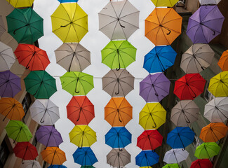 Colourful umbrellas hanging over the street