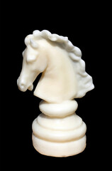 White chess piece on black background © pingvin57