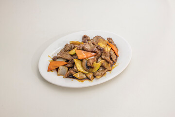 Typical dish of European Chinese restaurant. Chopped veal with vegetables, onions and bamboo with oyster sauce sauteed in the wok