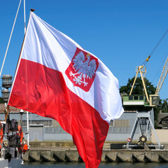 Naklejka na ściany i meble The national flag of Poland on the stern flagpole of the ship.