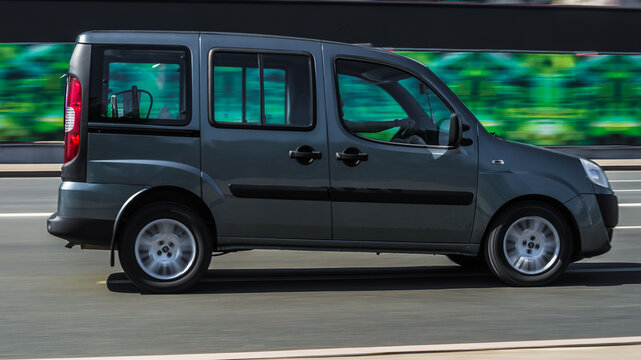 Fiat Doblo rides on the city road. Delivery van Fiat Doblo in motion