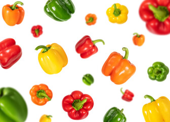 Set with flying colorful sweet peppers isolated on a white background. Falling bell pepper. Vegetable pattern.