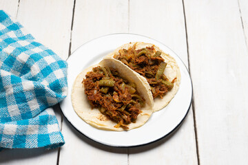 Mexican food. Chilorio and nopales tacos on white background