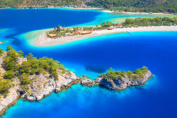 Aerial view of sea bay, rock, sandy beach, trees, mountain at sunny day in summer. Blue lagoon in...