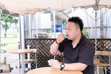 A man eating ice cream at a cafe