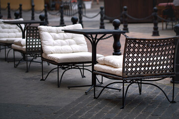 Empty chairs and tables in restaurant during pandemic. Summer terrace restaurant in city center. Summer outdoor cafe. Tables and chairs, summer cafe
