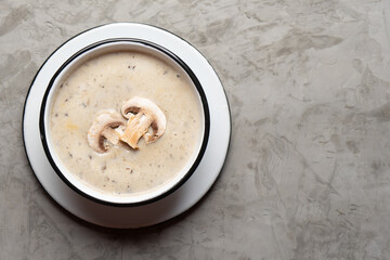 Cream of mushroom soup on grey background. Vegetarian food