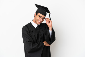 Young university graduate over isolated white background with glasses and happy