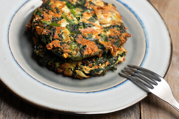 Spinach patties on a wooden background. Vegan food