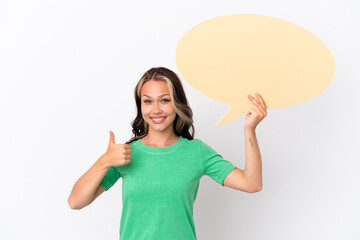 Teenager Russian girl isolated on blue background holding an empty speech bubble with thumb up