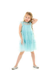 A little girl fixes her hair.The concept of beauty and fashion