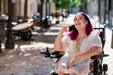 adult woman with disabilities using an smartphone on a sunny day outdoors