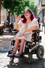 vertical photography of a woman in wheelchair using a smarphone - disabilities concept