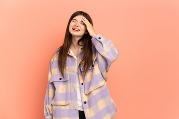 Young Ukrainian girl isolated on pink background smiling a lot