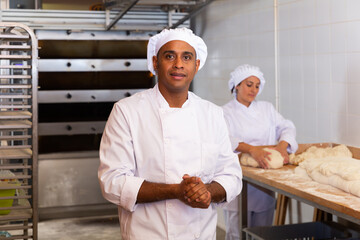 Portrait of confident latino chef in.bakery