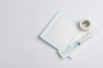 Healing implements. Syringe, gauze and adhesive tape on white background with space for text. Healing