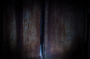 old rusty metal background or texture in dark room with light. Close up.