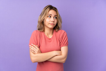 Fototapeta premium Teenager Russian girl isolated on purple background making doubts gesture while lifting the shoulders