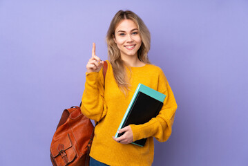 Teenager Russian student girl isolated on purple background pointing up a great idea