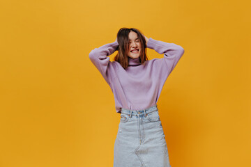 Happy young Asian girl smiles sincerely and ruffles hair on isolated. Pretty woman in denim skirt...