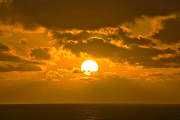 Sunset in Hawaii. The orange shimmer of the sea.  View from a sightseeing cruise ship.